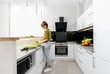 © rh2010 - Woman cooking healthy food on the modern kitchen at home, wide intreior view