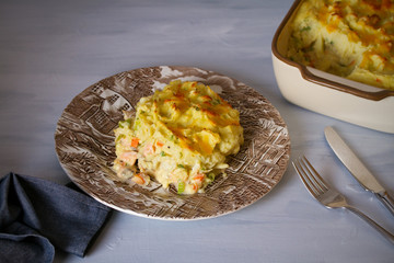 Wall Mural - Creamy fish pie: various types of fish, creamy sauce and cheesy potato topping. horizontal image