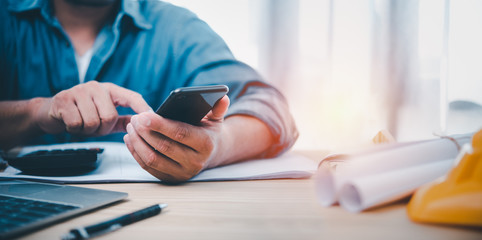Leinwandbilder - Hand man using smartphone for Searching Browsing Internet Data Information Networking Concept. Find information about building a house.