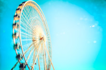 Blurred Motion Of Ferris Wheel Against Blue Sky