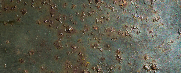 rusting old metal plate painted with green paint