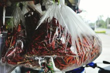 Dry Red Chilies Hanging In Plastic At Store