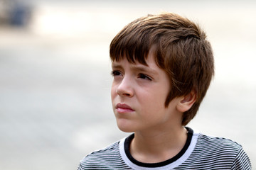 Portrait of handsome young boy thinking in a summer day outdoors