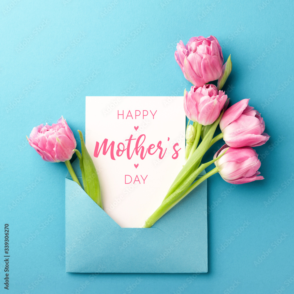 Bouquet of pink tulips in turquoise envelope on turquoise background. Happy Mother's Day greeting card. Flat lay, top view. - obrazy, fototapety, plakaty 