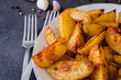 Golden spicy potato wedges fried or oven baked with garlic.