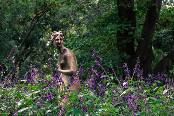 Nymph sculpture among lavender plants in bloom