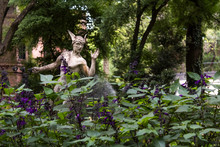 Hermes Sculpture In Purple Garden