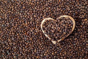 Aromatic roasted coffee beans in a wooden bowl