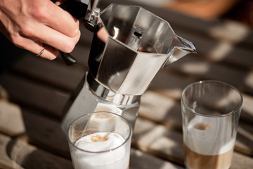 Pouring morning coffee from a Mokka pot