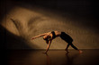 © Albert Law - Young Asian woman practicing yoga in moody studio during golden hour