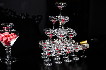 Pyramid of alcohol glasses with cherries at a party