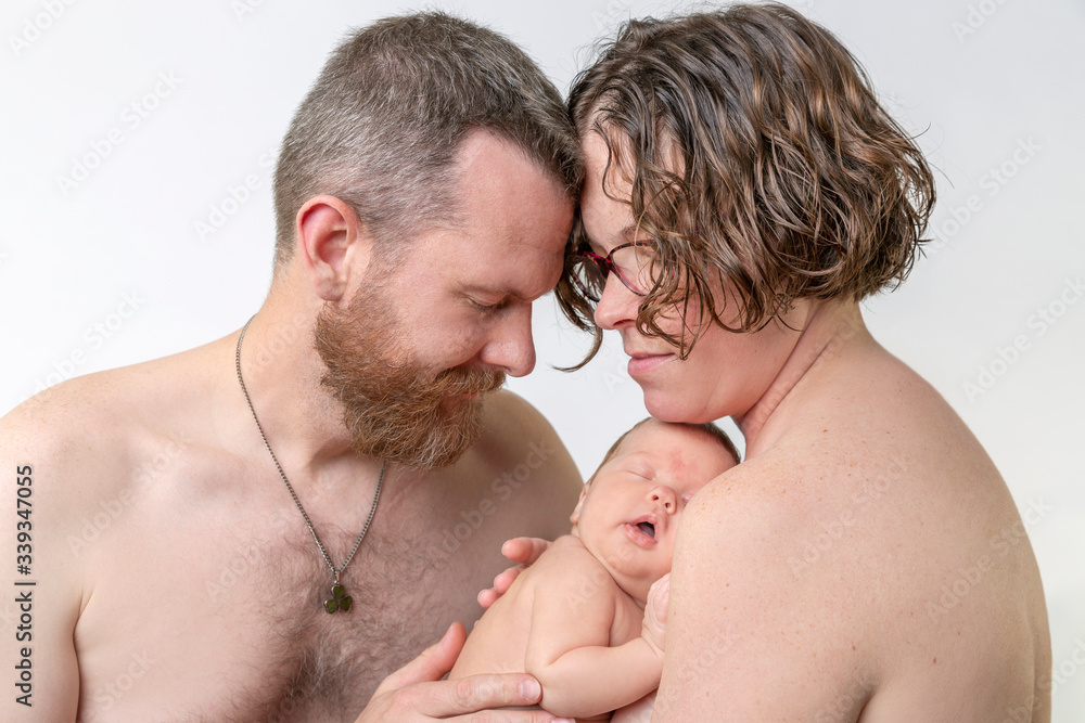 Family of mom, dad and baby sharing skin to skin bonding together Stock ...