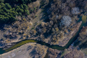 Wall Mural - Nature of Russia, Belgorod region, dark river against the background of spring forest, Sunny weather. Sunset light, Aerial View, HEAD OVER SHOT