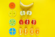 Colorful math fractions and apples, oranges, banana as a sample on yellow background or table. Interesting fun math for kids. Education, back to school concept. Geometry and mathematics materials.