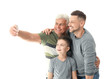 © Pixel-Shot - Man with his father and son taking selfie on white background