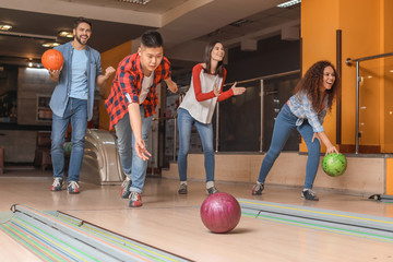 Wall Mural - Friends playing bowling in club