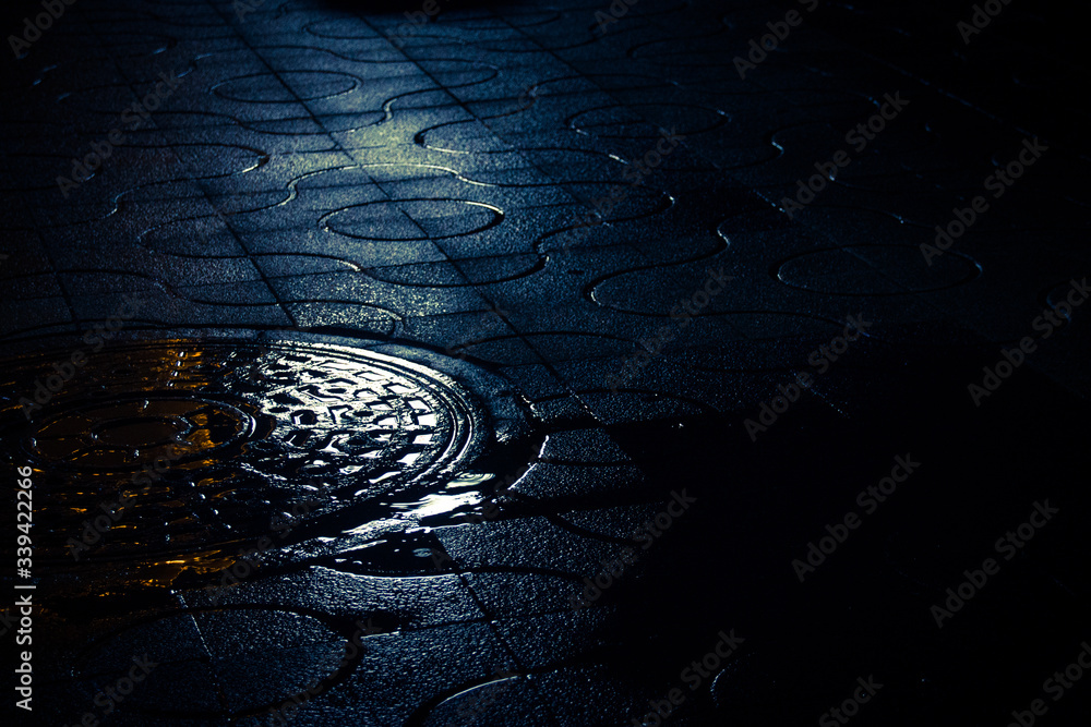 High Angle View Of Manhole On Street At Night - obrazy, fototapety, plakaty 