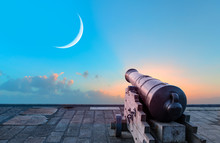 Ramadan Concept - Ramadan Kareem Cannon With Crescent - Night Sky With Moon In The Clouds At Sunset