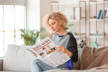 Poster - Beautiful young woman reading newspaper at home