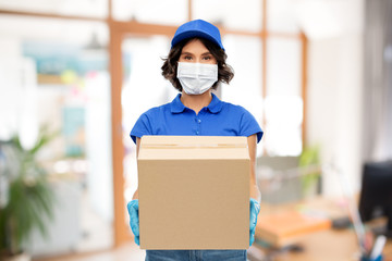 health protection, safety and pandemic concept - delivery woman in face protective mask and gloves holding parcel box over office background