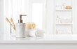 © didecs - Soap dispenser, toothbrushes and white towel on bathroom counter interior