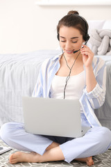 Sticker - Beautiful young woman working on laptop at home