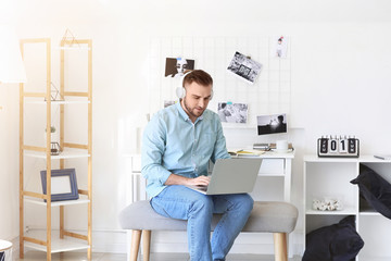 Poster - Young man with laptop working at home