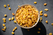 © Vladislav Noseek - Golden raisins or sultana in bowl on black background, table top view. Dried fruit, healthy snack food