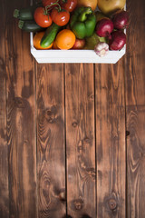 Wall Mural - Box with vegetables and fruits on a wood background from boards. Shopping, nutrition and lifestyle