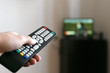 © Oleksandr - Hand of a man with a remote control from the TV.