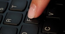 Black Keyboard And A Girl Pushes F Button. English Letters. Slow-mo And Girl Has A Pink Nail Polish.
