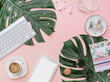 Modern flat lay  feminine workspace with stationery, Accessory on the pink table. Tropical View top. Still life scene