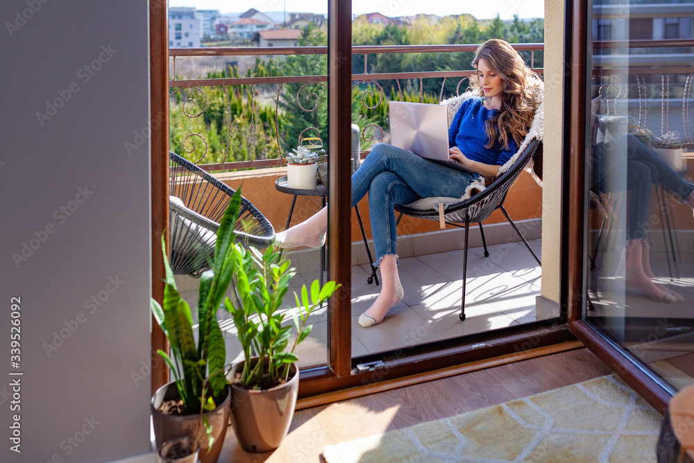 Beautiful young woman working from home on the balcony - obrazy, fototapety, plakaty 