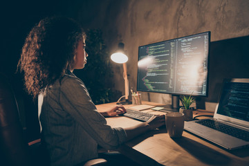 Profile side photo of focused skilled afro american girl web designer company administrator sit table desk work pc solve database mistakes make binary apps code in evening late workplace