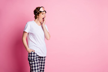 Poster - Photo of pretty tired lady hold hand near open yawning mouth sleepy eyes closed walk to bed wear eyes mask white t-shirt plaid pajama pants isolated pink color background