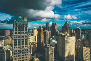 Cityscape of Detroit under the sunlight and a dark cloudy sky at daytime in Michigan in the US