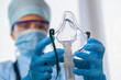 © Elroi - doctor in protective equipment put on oxygen mask patient diagnosis of coronavirus