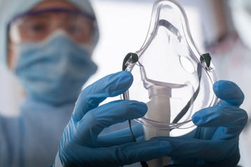 Wall Mural - doctor in protective equipment put on oxygen mask patient diagnosis of coronavirus