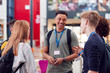 © Monkey Business - Group Of College Student Friends Meeting And Talking In Busy Communal Campus Building