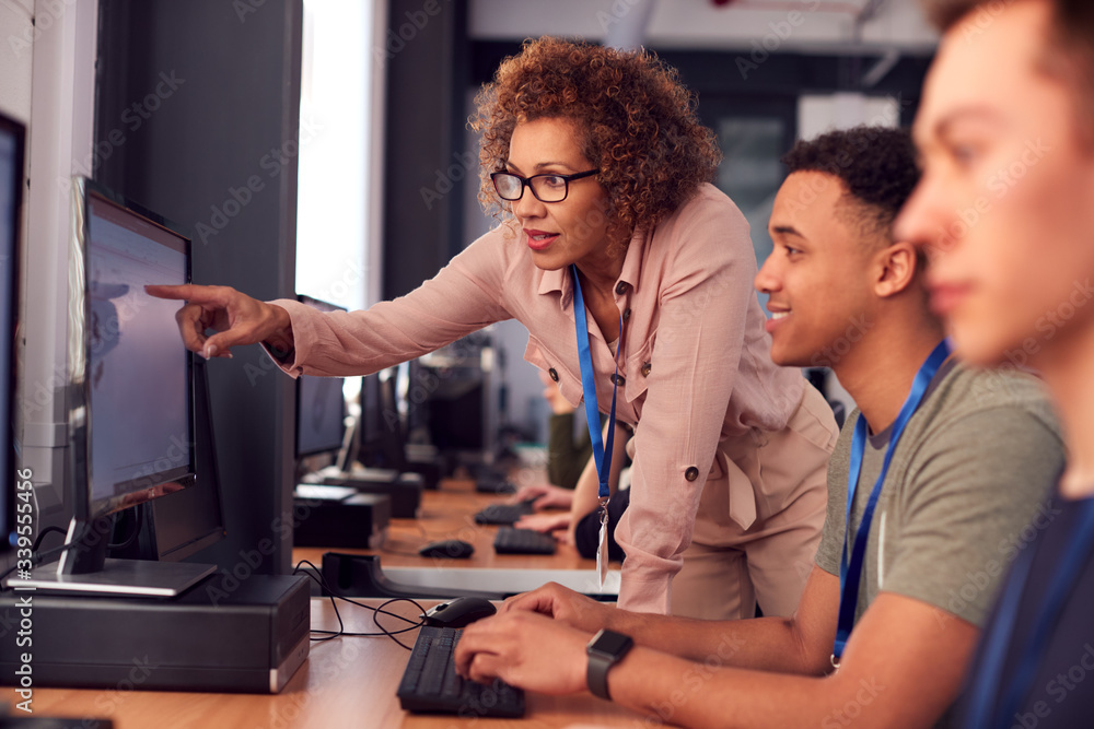 Group Of College Students With Tutor Studying Computer Design Sitting ...