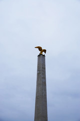 A high statue with a golden eagle