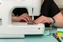Woman Sewing Using A Sewing Machine