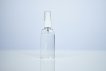 Sanitizer in a plastic spray on a white table. Coronavirus protection COVID-19.