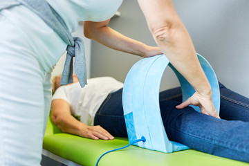 Alternative practitioner treats knees with magnetic field therapy