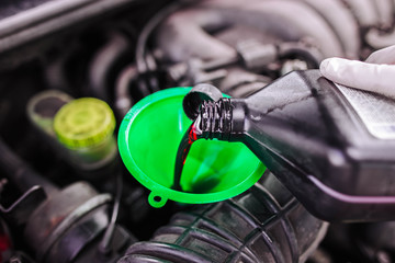 pour gear oil into the car through the watering can. replacement of technical fluids.