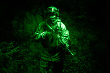 Portrait Of A Military Man In The Green Light Of A Night Vision Device. The Concept Of Military Operations, International Conflicts, Special Forces.