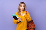 Fototapeta  - Teenager Russian student girl isolated on purple background surprised and shocked while looking right