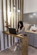 © September - Home office on the kitchen. Girl working on the laptop from home. Remote work and online education