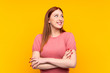 © luismolinero - Young redhead woman over isolated yellow background laughing