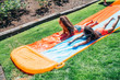 © Inti St. Clair - Girls playing on slip and slide in front yard of home